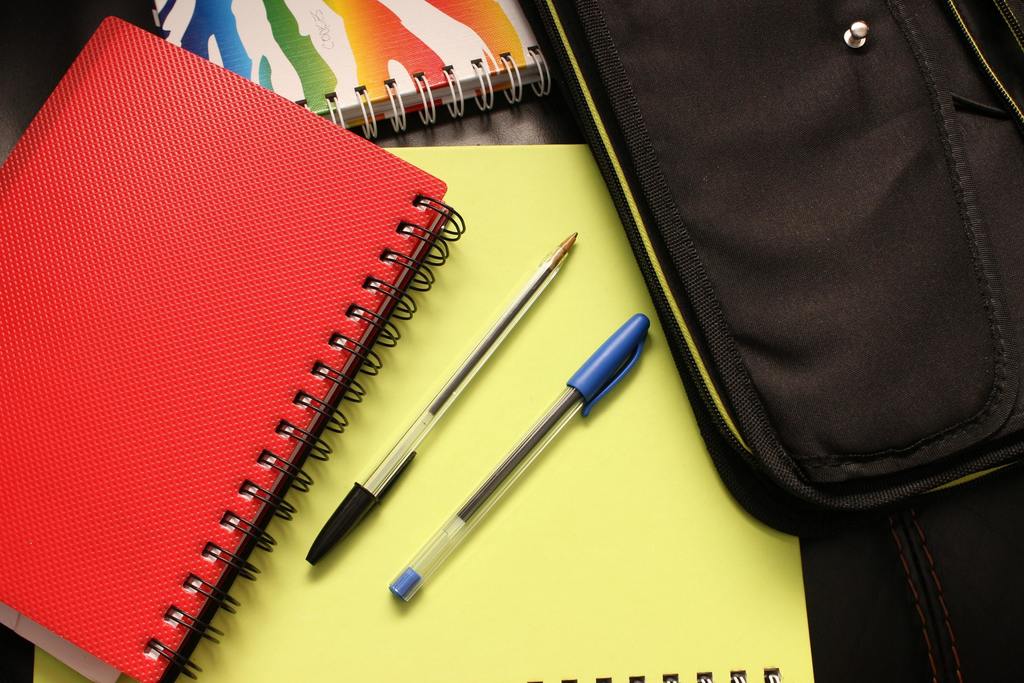 pens,notebooks, bag on a desk
